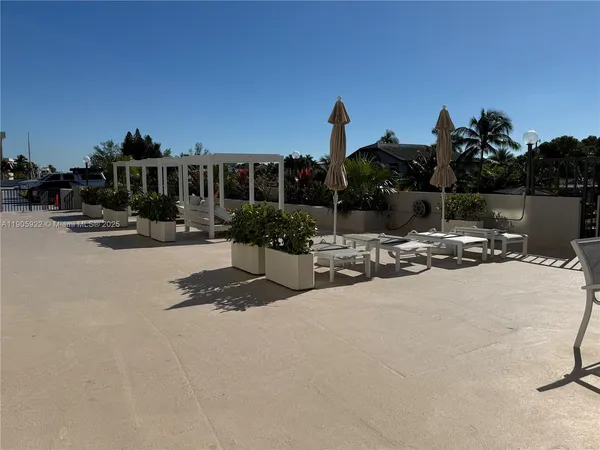 a view of a patio with table and chairs and potted plants