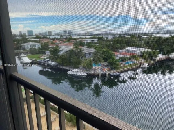 a view of a house with a yard in a forest