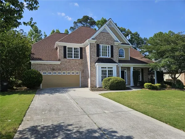 a front view of a house with a yard