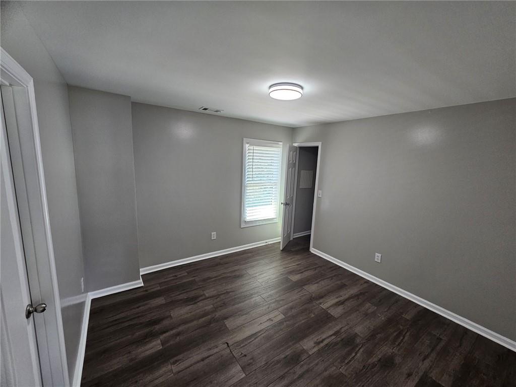 1755 Wheat Grass Way Grayson, GA 30017 - Photo 24 of 42 a view of an empty room with wooden floor and a window