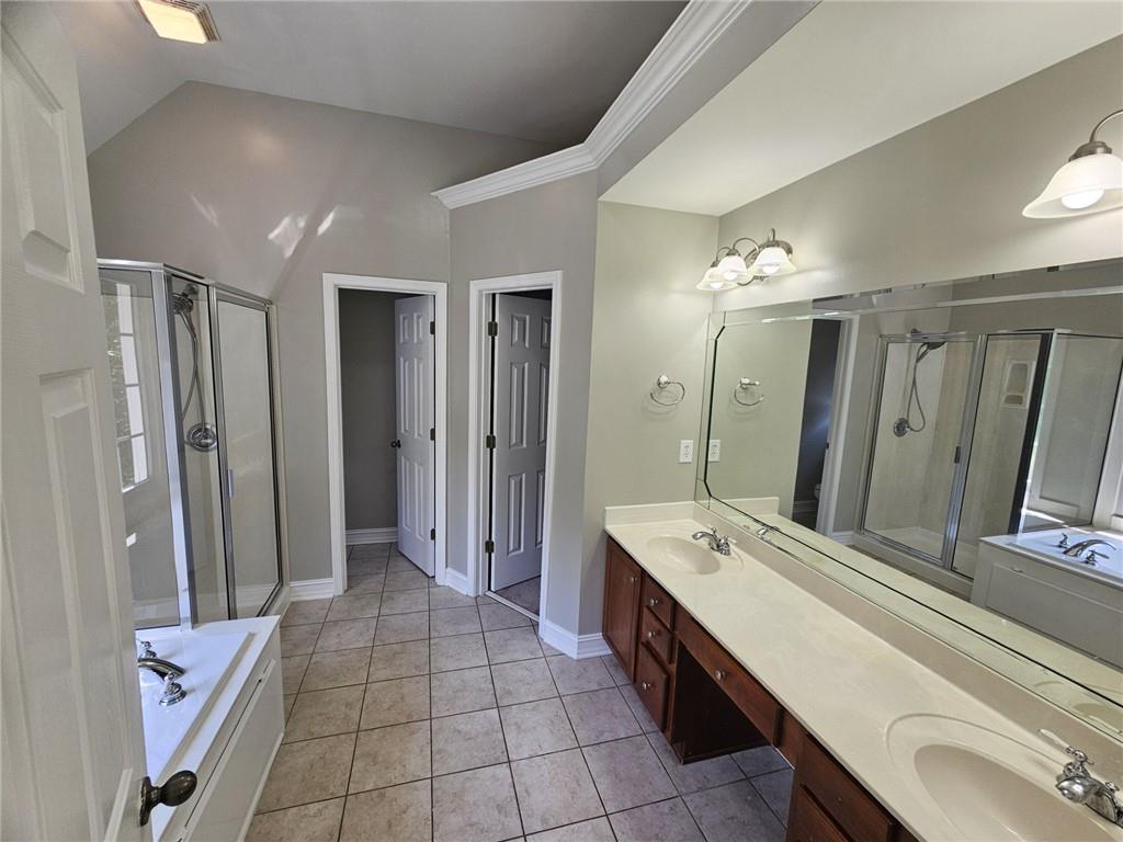 1755 Wheat Grass Way Grayson, GA 30017 - Photo 31 of 42 a large bathroom with a double vanity sink a large mirror and a shower