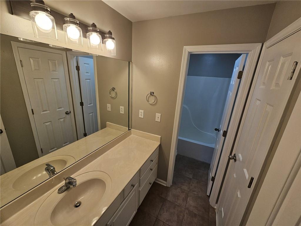 1755 Wheat Grass Way Grayson, GA 30017 - Photo 32 of 42 a bathroom with a sink a mirror and a shower