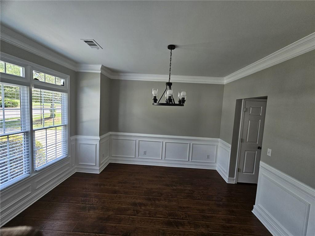 1755 Wheat Grass Way Grayson, GA 30017 - Photo 7 of 42 a view of an empty room with wooden floor and a window