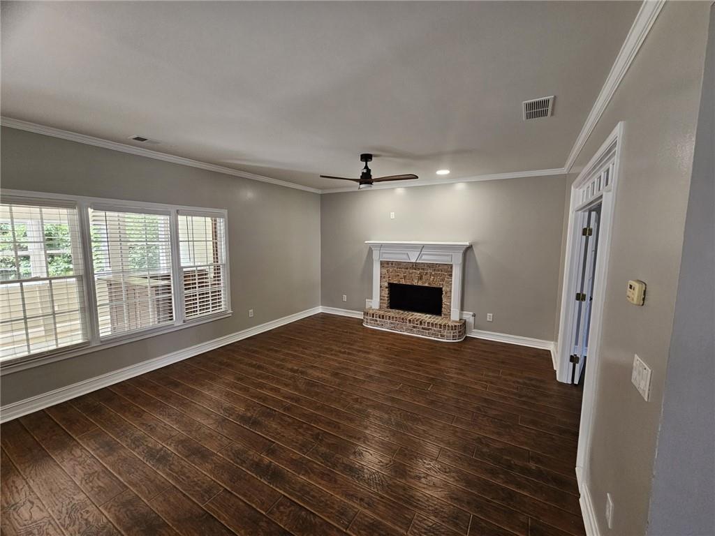 1755 Wheat Grass Way Grayson, GA 30017 - Photo 8 of 42 a view of empty room with wooden floor and fireplace