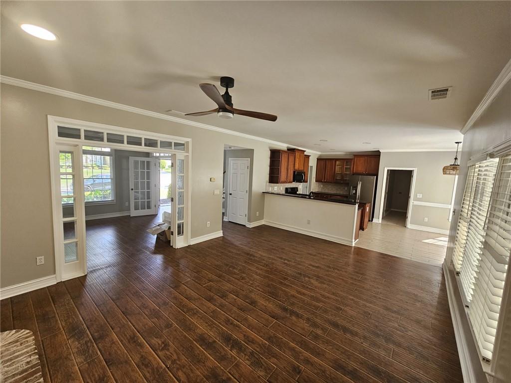 1755 Wheat Grass Way Grayson, GA 30017 - Photo 10 of 42 a view of a living room and kitchen with furniture wooden floor and ceiling fan
