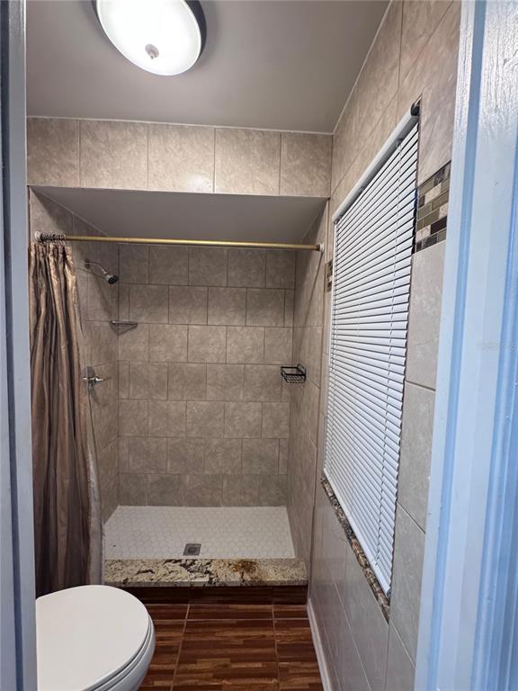 138 Pinewood Circle Kissimmee, FL 34743 - Photo 18 of 26 a bathroom with a shower and a toilet