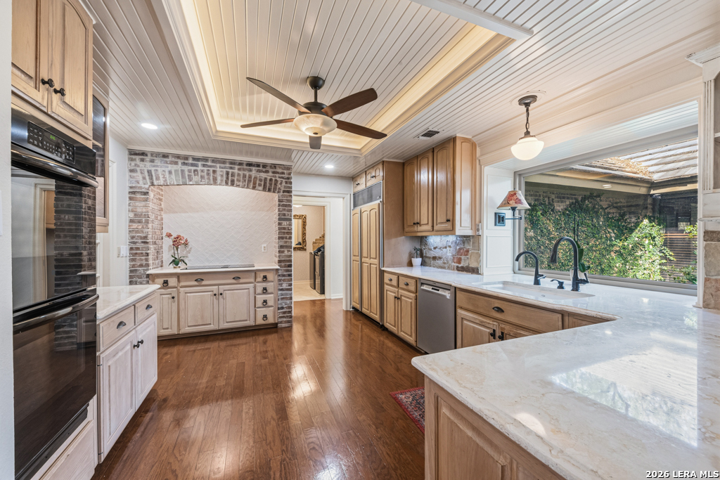 21749 Forest Waters Circle Garden Ridge, TX 78266 - Photo 12 of 50 a kitchen with stainless steel appliances kitchen island granite countertop a stove refrigerator and cabinets