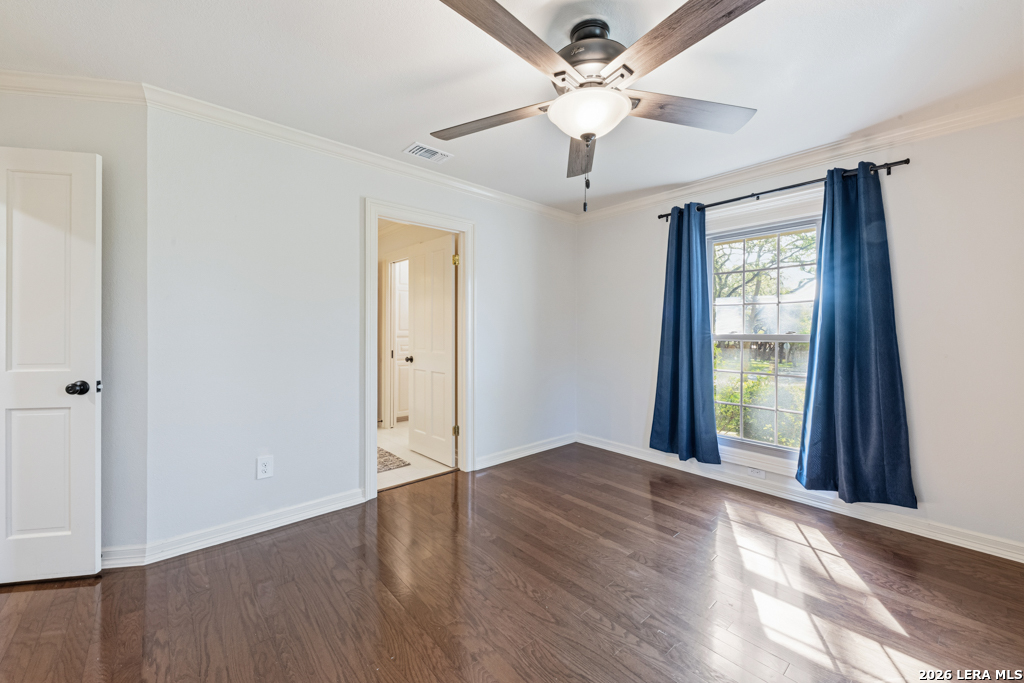 21749 Forest Waters Circle Garden Ridge, TX 78266 - Photo 21 of 50 an empty room with wooden floor chandelier fan and windows