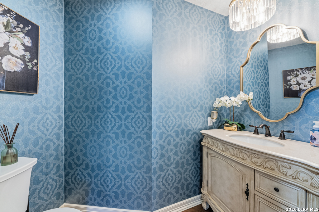 21749 Forest Waters Circle Garden Ridge, TX 78266 - Photo 24 of 50 a bathroom with a granite countertop sink a toilet and a mirror