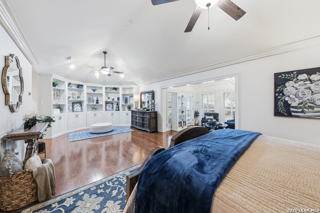21749 Forest Waters Circle Garden Ridge, TX 78266 - Photo 26 of 50 a spacious bedroom with a large bed and a chandelier