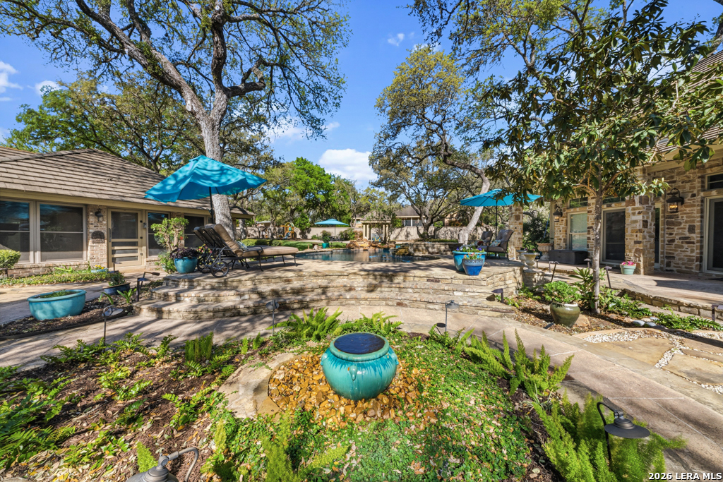 21749 Forest Waters Circle Garden Ridge, TX 78266 - Photo 32 of 50 a view of a backyard with plants and patio