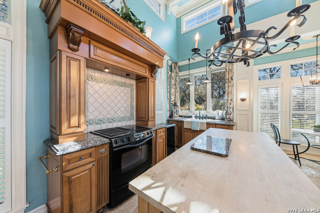 21749 Forest Waters Circle Garden Ridge, TX 78266 - Photo 41 of 50 a kitchen with stainless steel appliances granite countertop a stove and a refrigerator