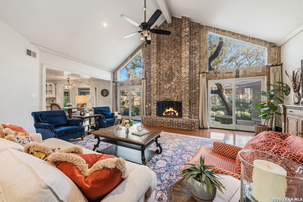 21749 Forest Waters Circle Garden Ridge, TX 78266 - Photo 7 of 50 a living room with furniture a fireplace and a floor to ceiling window
