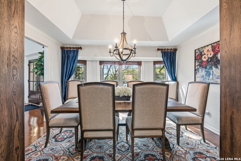 21749 Forest Waters Circle Garden Ridge, TX 78266 - Photo 9 of 50 a dining room with furniture a chandelier and wooden floor