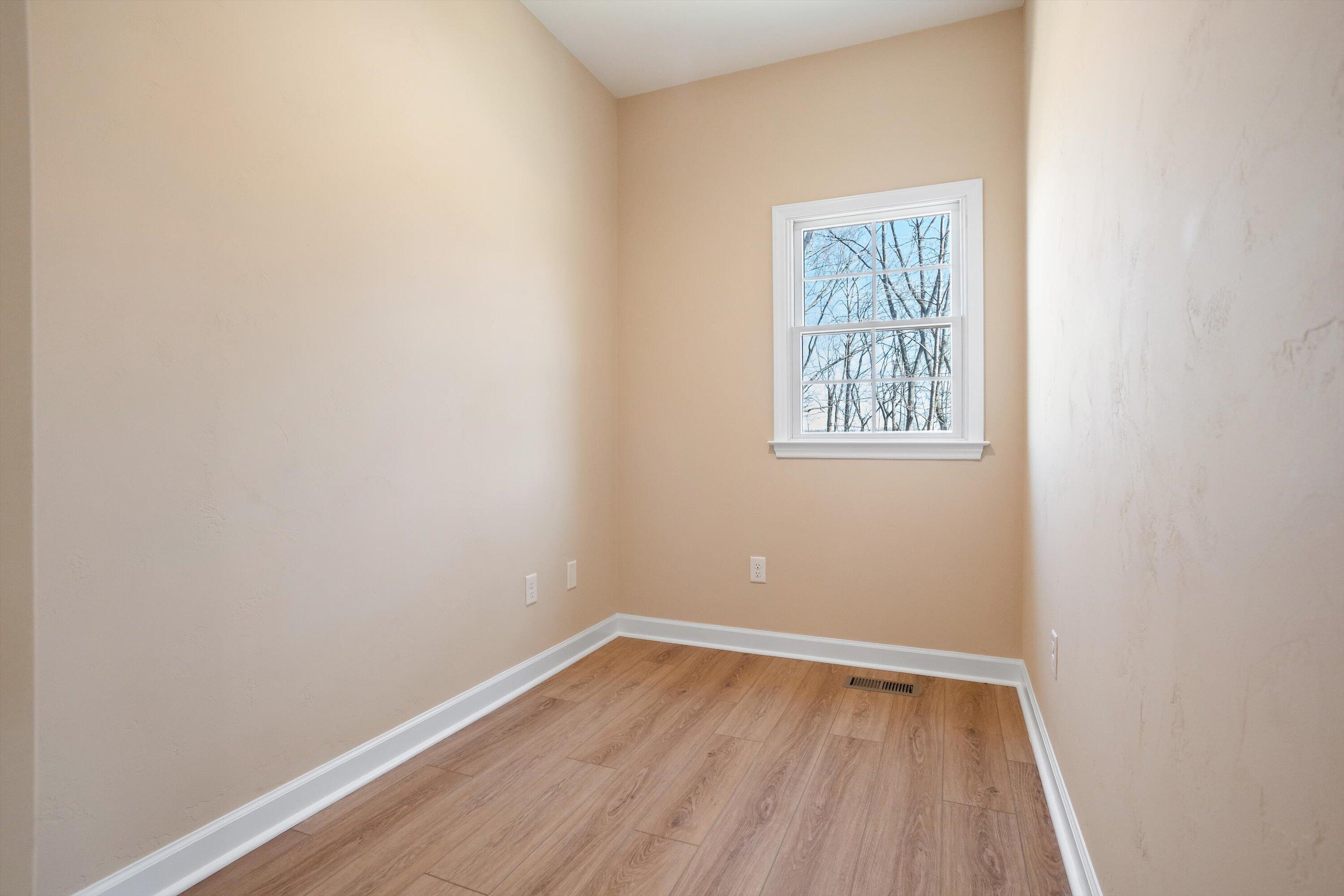 129 Walnut Trace Drive Hardy, VA 24101 - Photo 11 of 42 a view of an empty room with wooden floor and a window