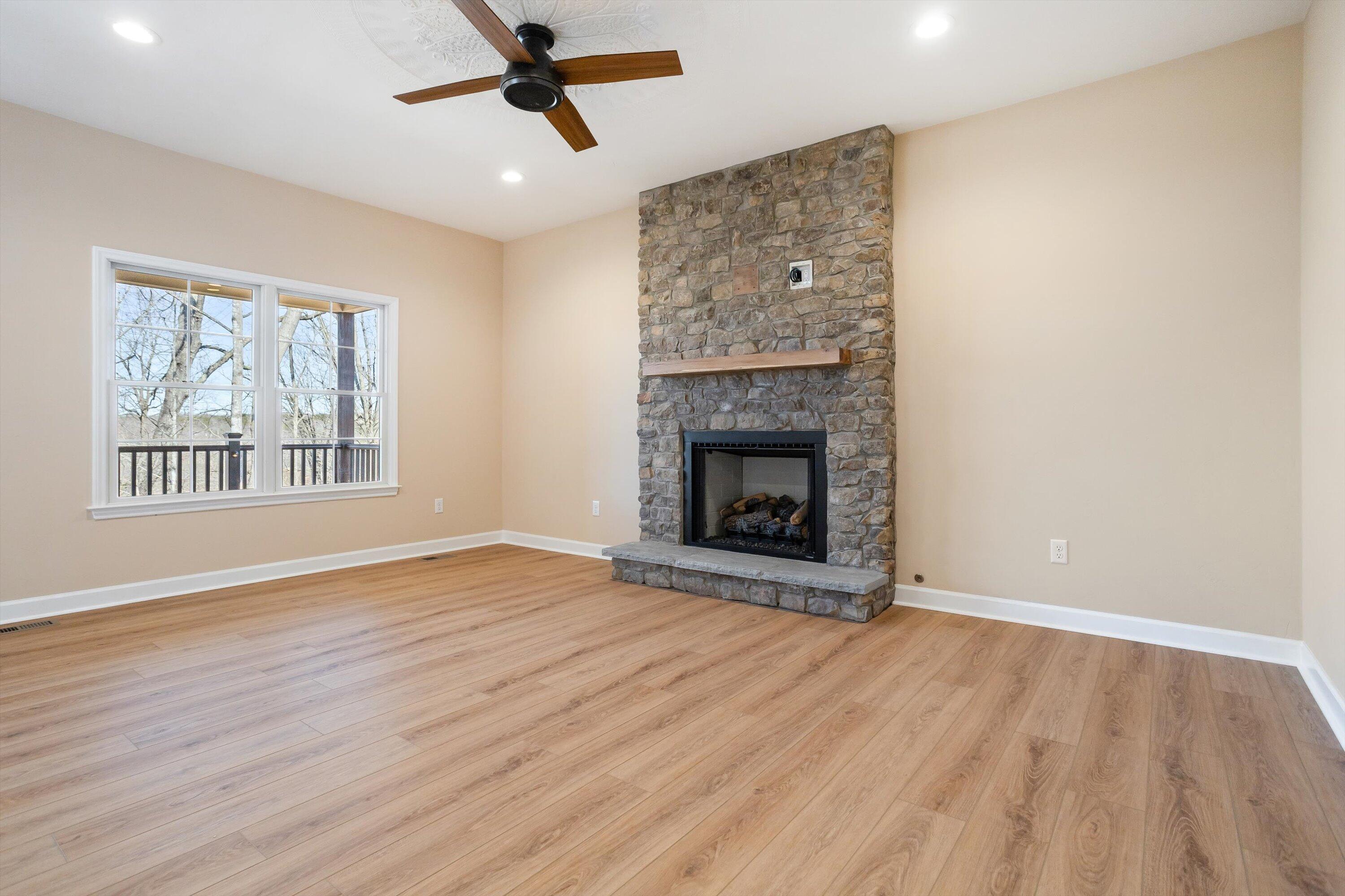 129 Walnut Trace Drive Hardy, VA 24101 - Photo 12 of 42 an empty room with windows fireplace and wooden floor