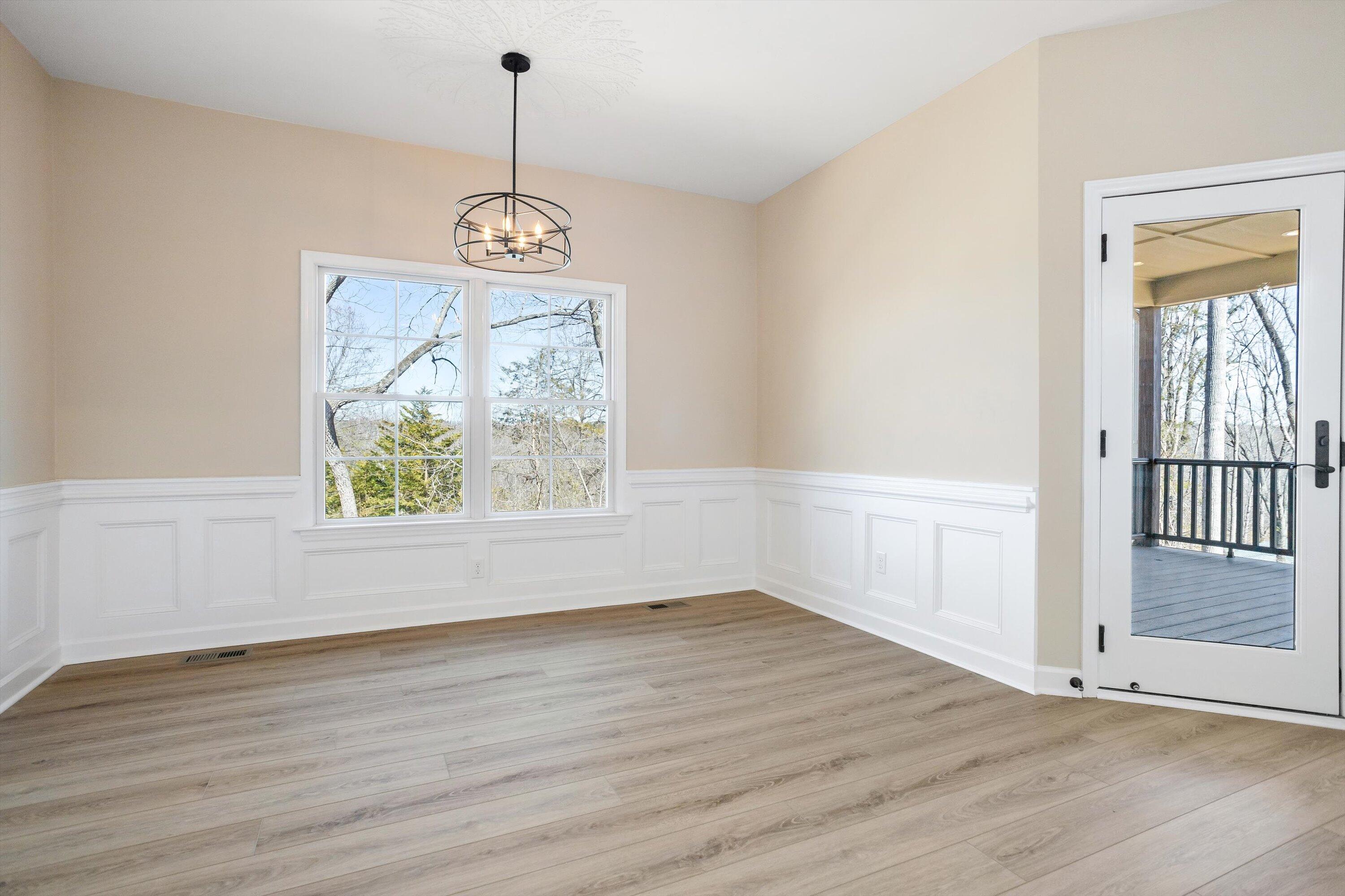 129 Walnut Trace Drive Hardy, VA 24101 - Photo 18 of 42 an empty room with wooden floor cabinet and windows