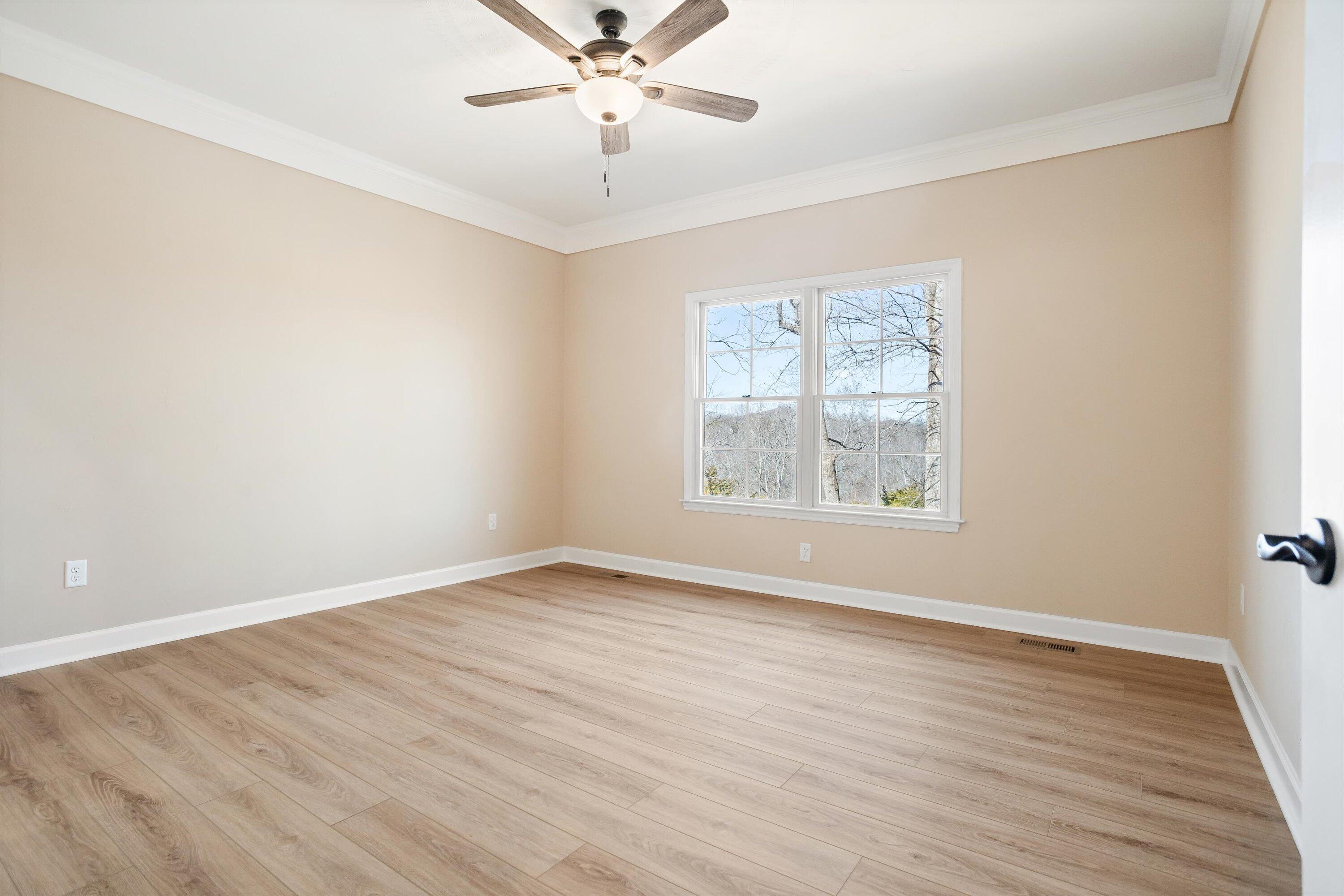 129 Walnut Trace Drive Hardy, VA 24101 - Photo 22 of 42 an empty room with wooden floor chandelier fan and windows