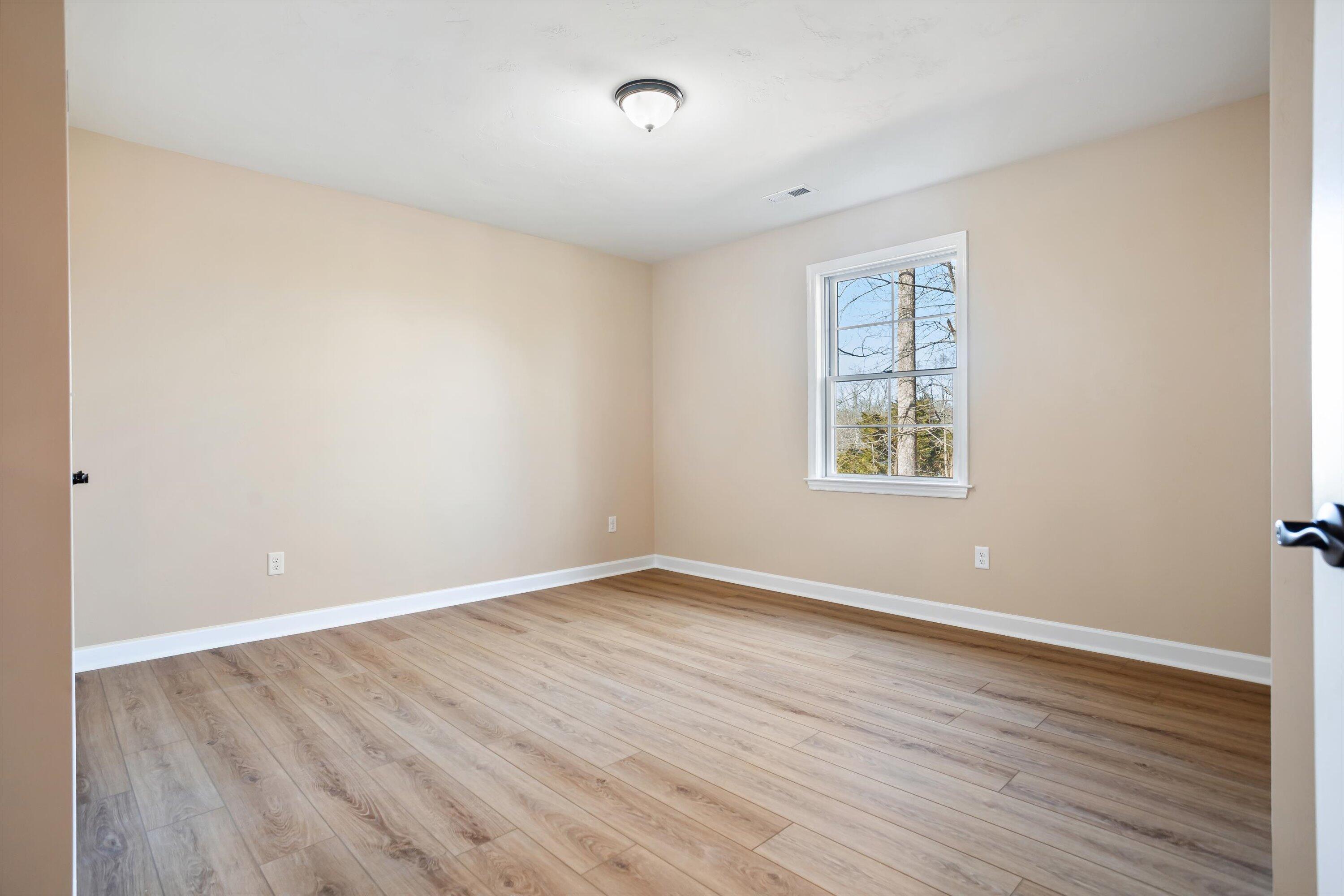 129 Walnut Trace Drive Hardy, VA 24101 - Photo 31 of 42 an empty room with wooden floor and windows