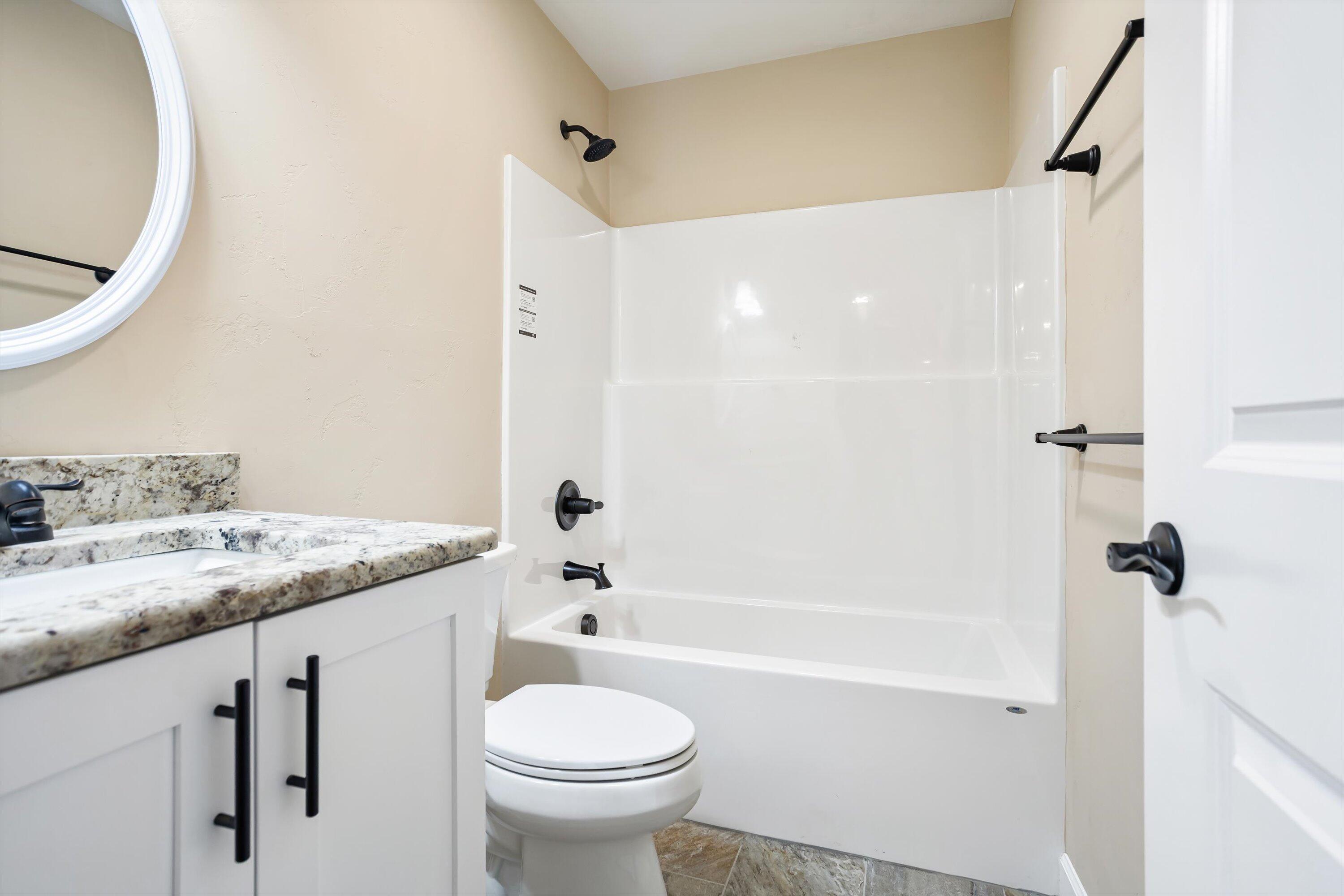 129 Walnut Trace Drive Hardy, VA 24101 - Photo 33 of 42 a bathroom with a granite countertop sink toilet and shower