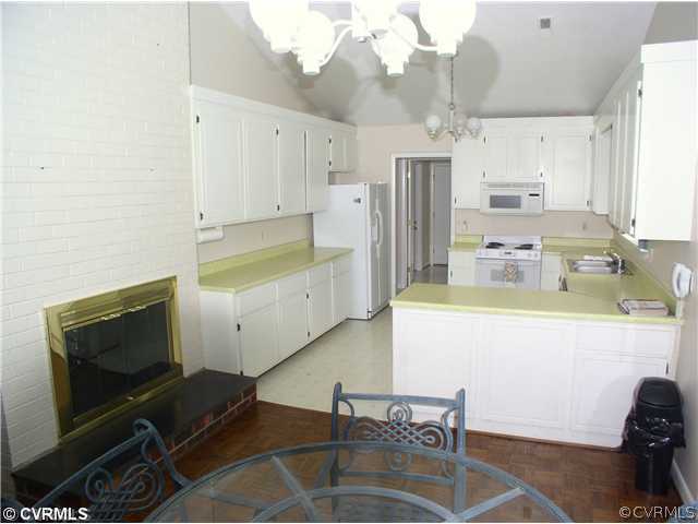 10930 Pegwell Drive Midlothian, VA 23113 - Photo 8 of 12 a kitchen with a stove a refrigerator and a sink