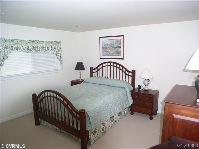10930 Pegwell Drive Midlothian, VA 23113 - Photo 10 of 12 a bedroom with a bed and a desk
