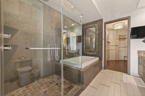 a spacious bathroom with a bathtub and a shower