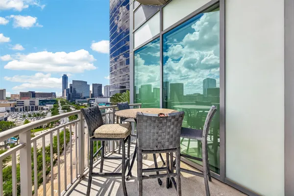 a view of a chairs and table in the balcony