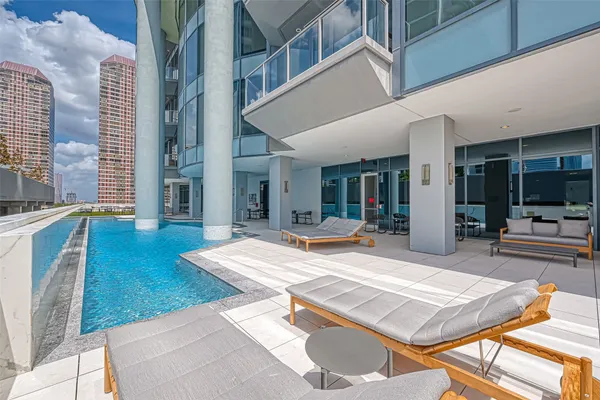 a view of a patio with swimming pool table and chairs
