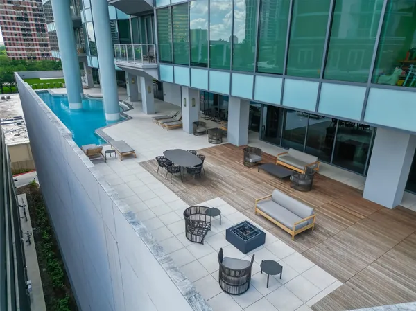 a view of backyard of roof deck dining table and chairs
