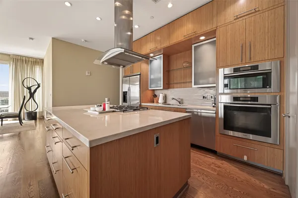 a kitchen with a sink stainless steel appliances and cabinets