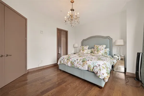 a bedroom with a bed and a chandelier