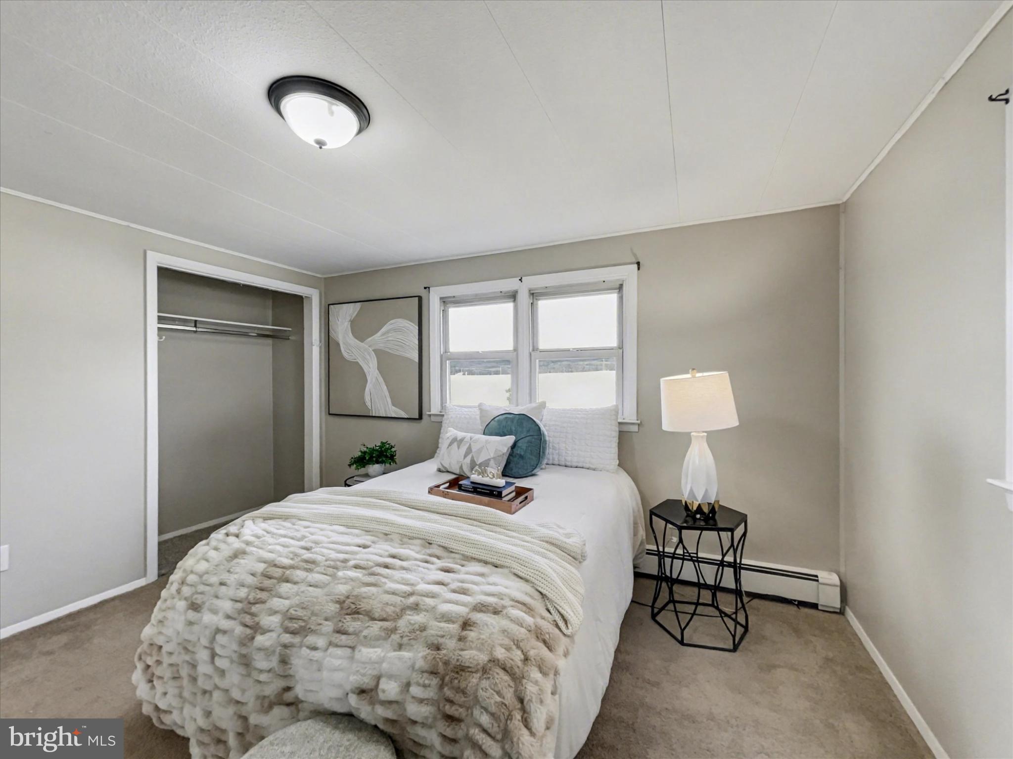 4968 Fairfield Road Fairfield, PA 17320 - Photo 17 of 32 a bedroom with a bed and a lamp