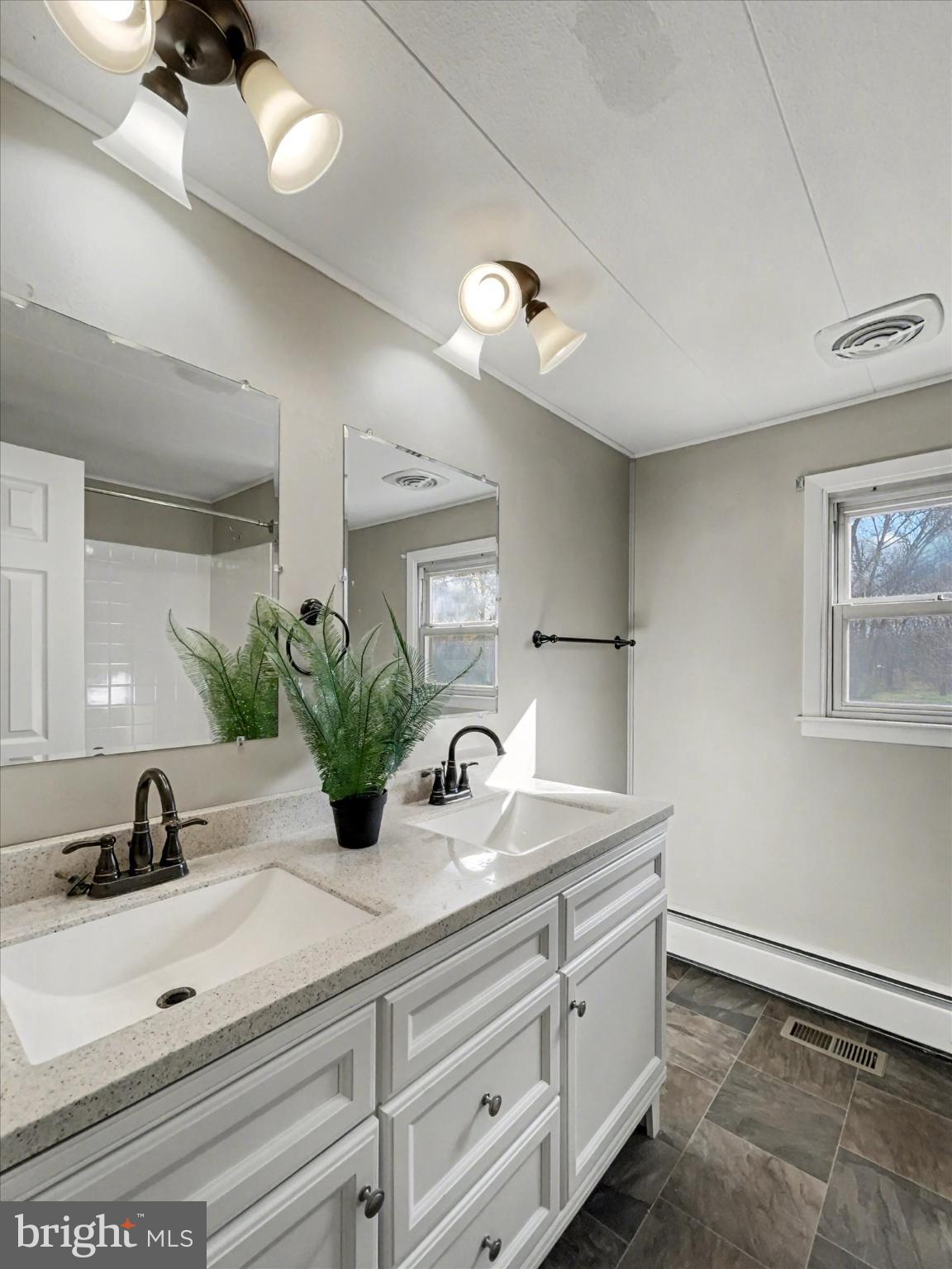 4968 Fairfield Road Fairfield, PA 17320 - Photo 18 of 32 a bathroom with a double vanity sink and a mirror