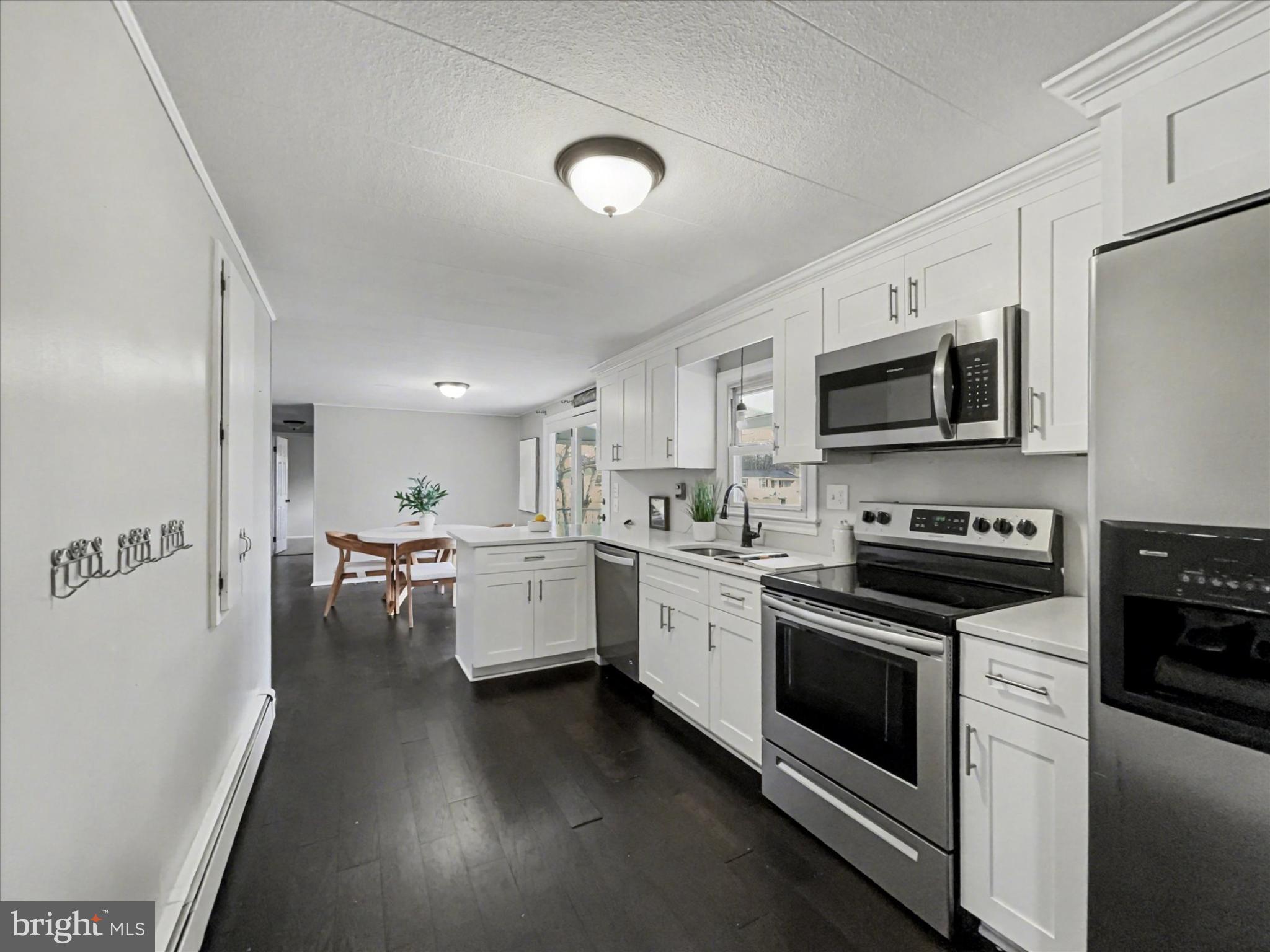 4968 Fairfield Road Fairfield, PA 17320 - Photo 9 of 32 a kitchen with stainless steel appliances a stove a sink cabinets and a refrigerator