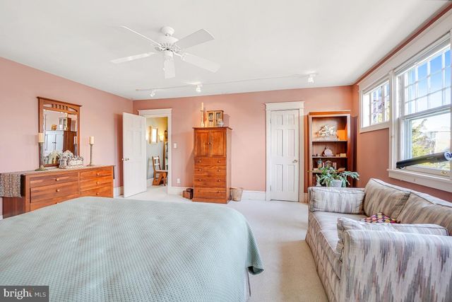 a bedroom with furniture and a mirror