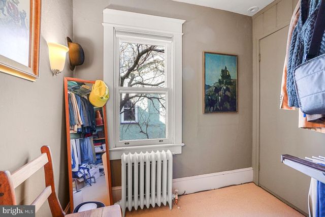 a bedroom with two beds and a dresser