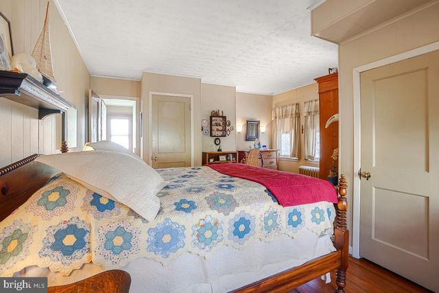 a living room with furniture a rug and a book shelf