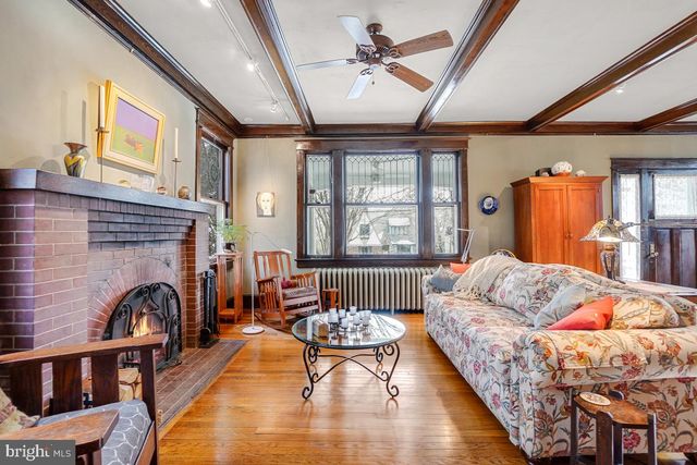 a living room with furniture a dining table and a floor to ceiling window