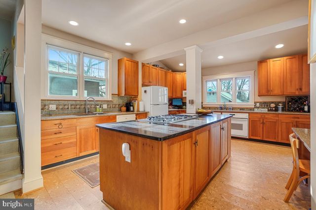 a kitchen with stainless steel appliances a sink a stove and a window