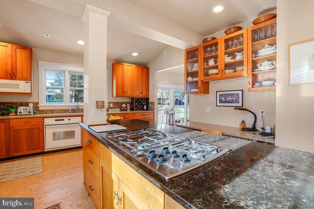 a dining room with furniture a chandelier and a rug