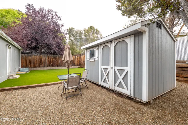 a view of backyard of house and deck