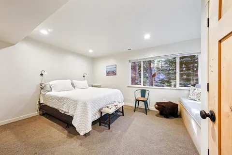a spacious bedroom with a bed and a large window