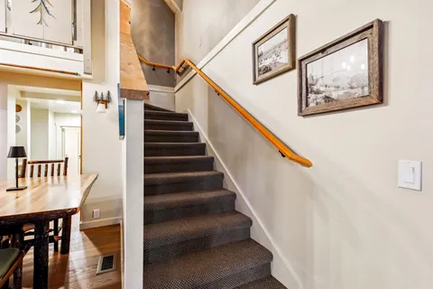 a view of entryway and hall with wooden floor
