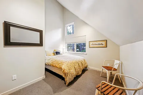 a bedroom with a bed and chair
