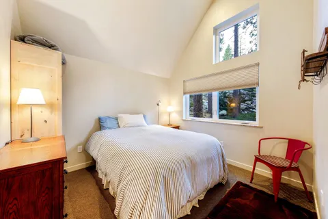 a bedroom with a large bed and a window