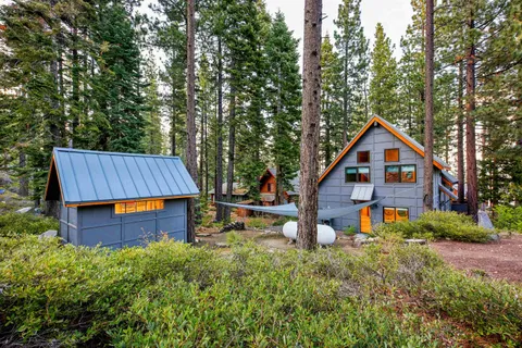 a backyard of a house with wooden fence and trees