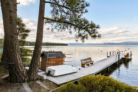 an outdoor sitting area with furniture and wooden floor