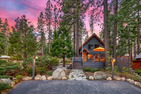 a front view of a house with tree s