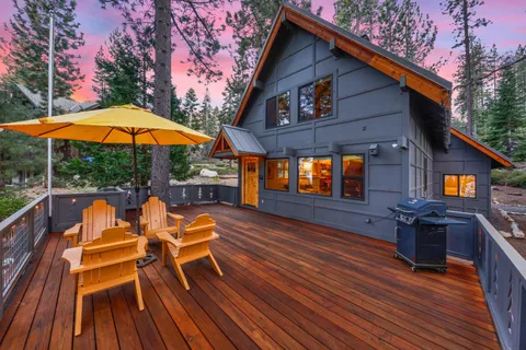 a view of house with deck and outdoor seating